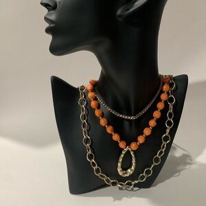 Gold tone and coral layered necklace.
